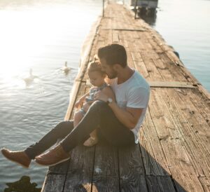 father and young son at on a dock at the lake father and young son at on a dock at the lake