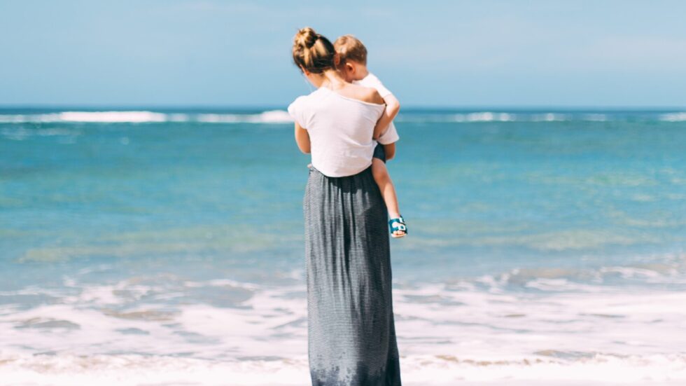 mother and young son at the ocean