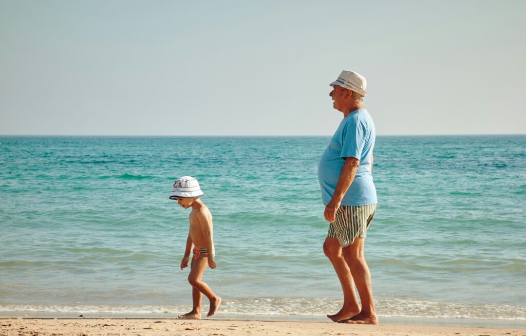 grandfather and grandchild at beach family reunion