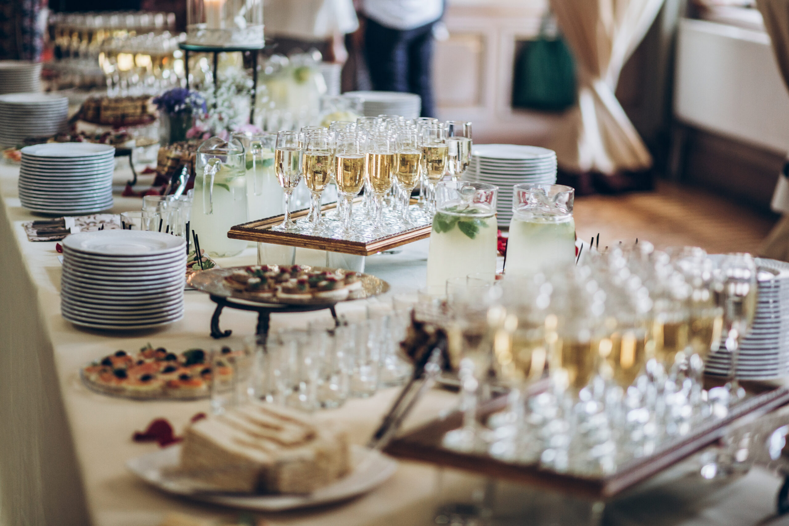 stylish champagne glasses and food  appetizers on table at wedding reception. luxury catering at celebrations. serving food and drinks at events concept