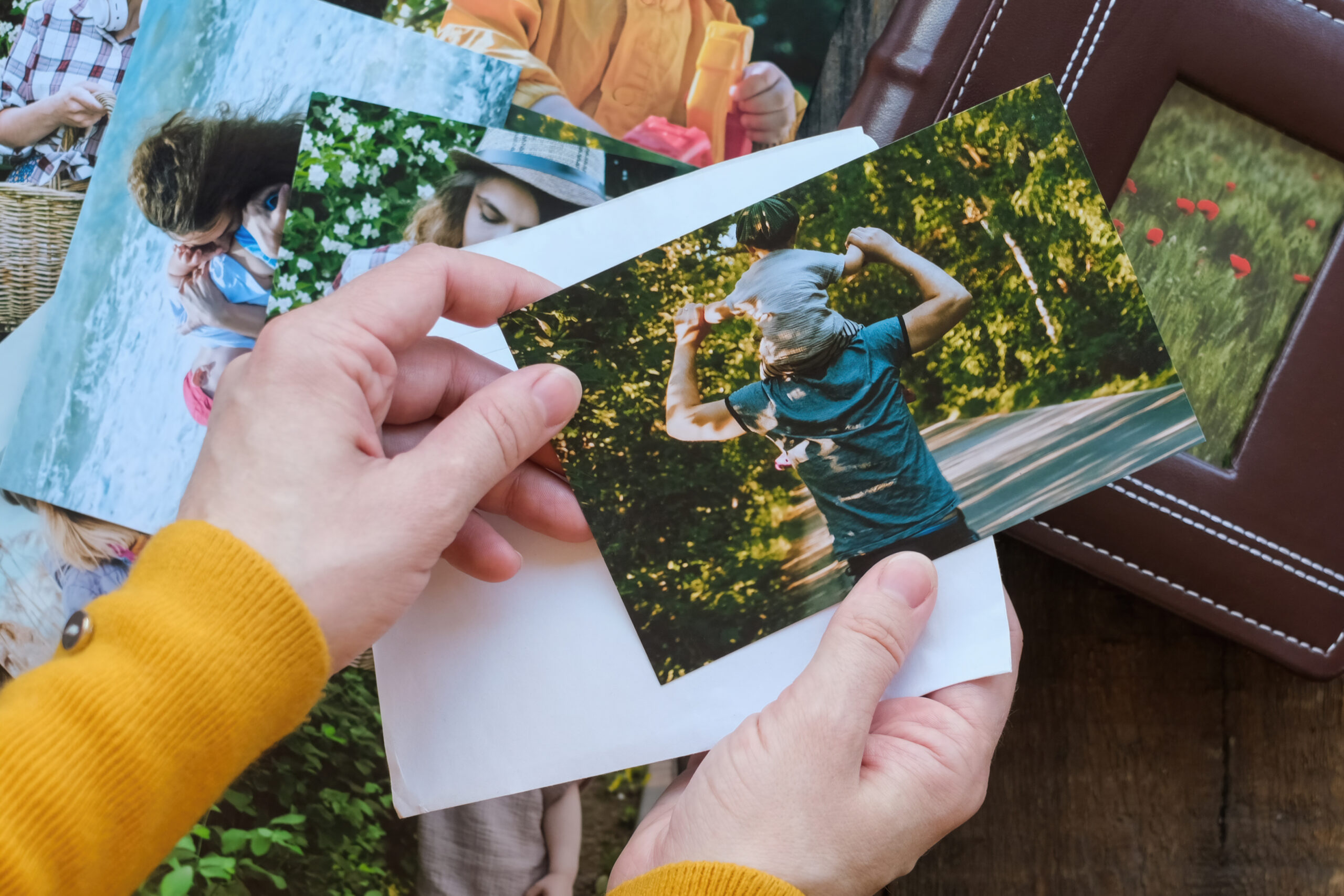 Woman looks at printed photos for family photo album.