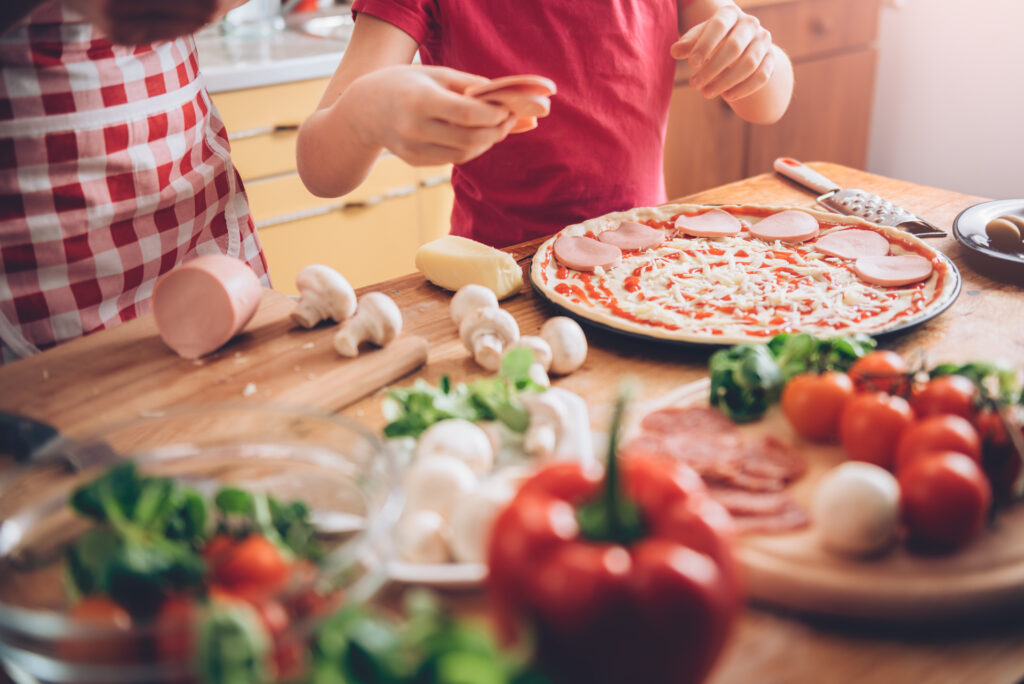 Mother and daughter preparing pizza