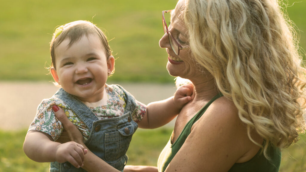 Happy grandmother with baby smiling